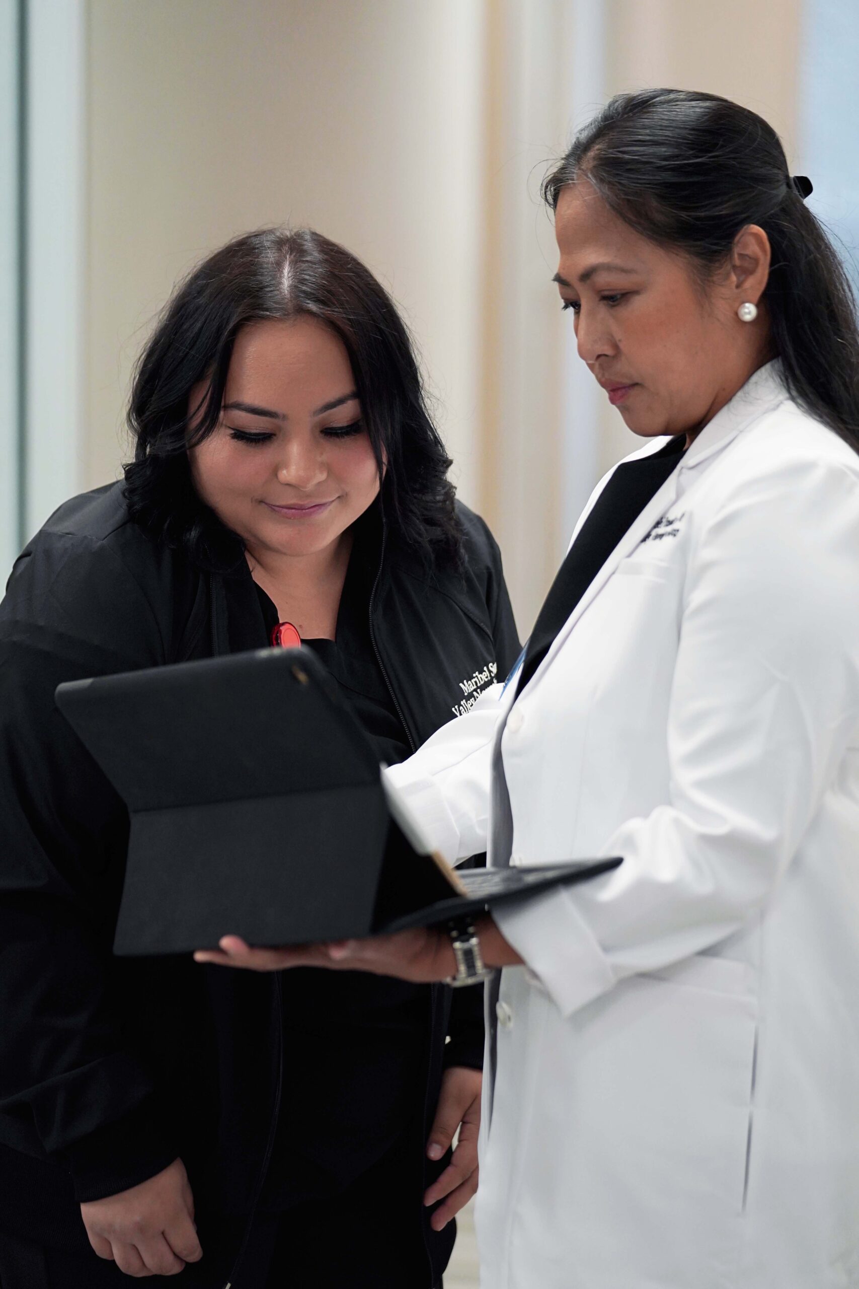 Two Valley Neurology Group team members reviewing information together on a tablet